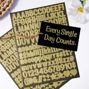 Close-up of 0.5-inch gold glitter alphabet and number stickers on black backing