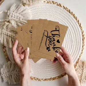 Macro view of hands holding vintage kraft paper thank you cards for small business