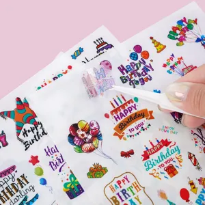 Close-up showing waterproof Happy Birthday sticker being peeled with white tweezers