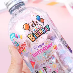 Close-up of waterproof cartoon birthday stickers applied on a plastic water bottle