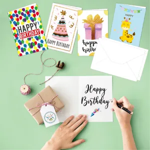 Flat lay of colorful birthday greeting cards with envelopes and a small gift box accessory