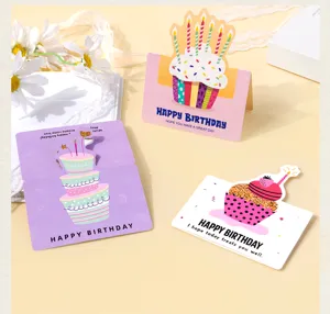 Detailed view of three 3D pop-up birthday cards with cake designs and greetings.