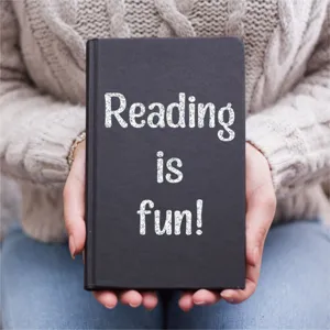 Detail of silver glitter alphabet stickers spelling 'Reading is fun' on a black book