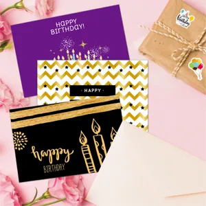Detailed view of three elegant birthday cards featuring gold and purple festive motifs