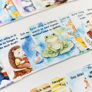 Macro view of children's SEL affirmation cards with cute watercolor animals and German text
