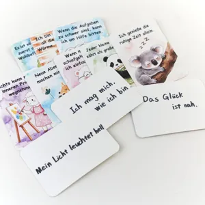 Detailed view of children's SEL affirmation cards with German mindfulness quotes and art