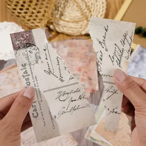 Detail view of vintage scrapbooking paper featuring handwritten script and realistic torn edges