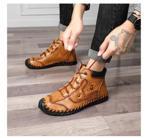 Detailed shot of a person tying the laces on brown vintage leather work boots.