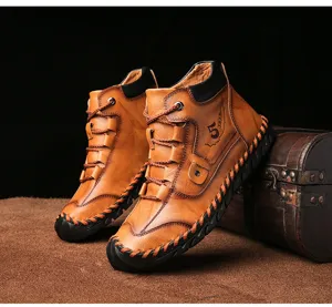 Detailed side view of vintage brown leather mid-top work boots for men with visible stitching