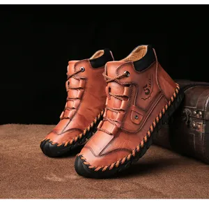 Macro view of vintage brown leather men's boots with decorative stitching and embossing.