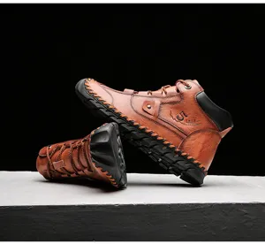 Detail of vintage brown leather men's work boots with durable stitching and soft sole.