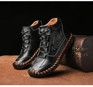 Close-up detail of handmade black leather boots with orange contrast stitching and retro design