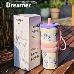 Stainless steel insulated tumbler with straw and cute bow design, perfect for cold drinks.