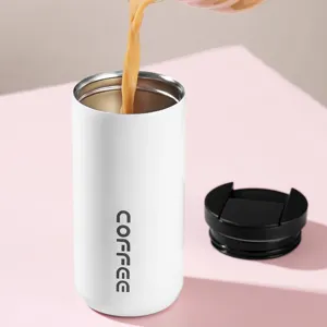 White 304 stainless steel insulated coffee tumbler with black lid and pouring coffee