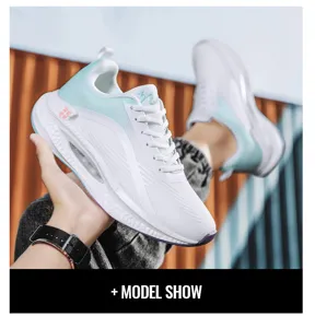 Detail view of lightweight white and teal sports sneakers with mesh breathable upper