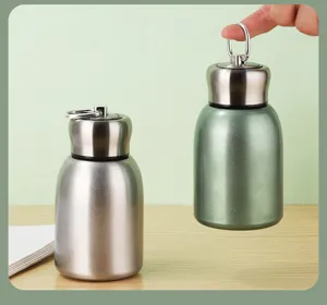 Mini stainless steel thermos bottles in silver and green with portable ring handle