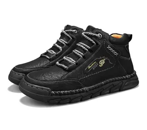 Detailed side view of black men's mid-top work boots with white stitching and grey laces