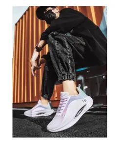 Detailed view of lightweight white and purple gradient mesh sports sneakers worn by a model.