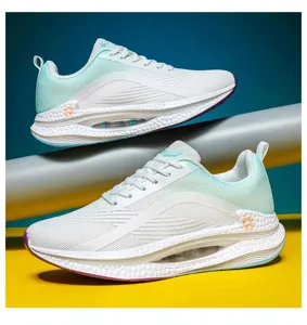 Detailed side view of white and mint green lightweight breathable sports shoes for adults