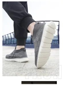 Vue rapprochée de baskets de marche d'extérieur en maille grise avec semelles blanches durables