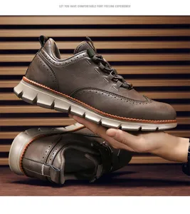 Seitenansicht eines braunen Leder-Brogue-Sneakers, der von der Hand gehalten wird.