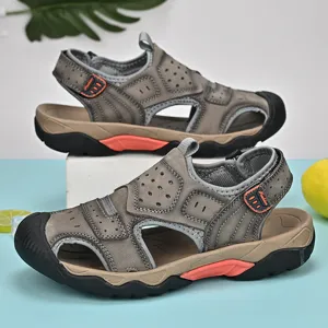 Detail shot of men's genuine leather outdoor sandals with breathable design in grey and orange.