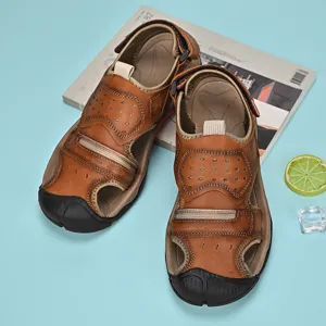 Top view of durable brown leather men's outdoor leisure sandals on blue background