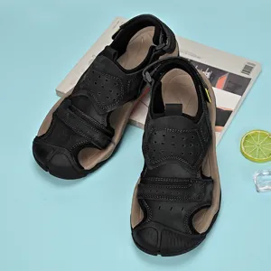 Top-down view of men's black genuine leather outdoor beach sandals on blue background