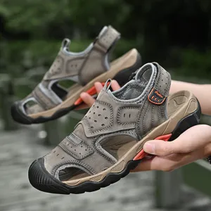 Close-up view of durable men's genuine leather outdoor sandals in earth brown with rubber toe cap.