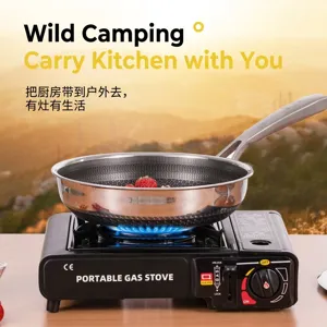 Portable outdoor camping gas stove with stainless steel frying pan in scenic nature setting