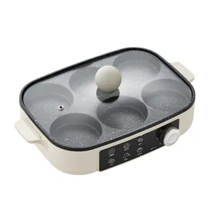 Detail of a 6-hole multi-functional electric breakfast cooker with a non-stick coating.