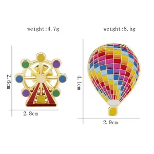 Detailed size view of colorful enamel hot air balloon and Ferris wheel brooches.