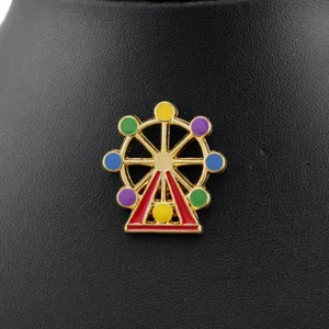 Close-up macro view of a vibrant colorful ferris wheel enamel pin with gold alloy plating