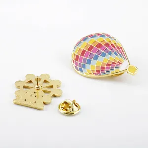 Detailed view of colorful hot air balloon enamel pin and golden ferris wheel base
