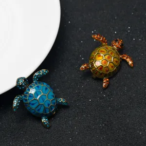 Cute sea turtle rhinestone brooches detailed view, sparkling crystal marine animal pin.