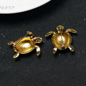 Close-up detail view of the back pin structure of gold alloy cute turtle brooch design.