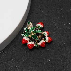 Close-up detail of rhinestone strawberry brooch, exquisite fruit design accessory for outfits.