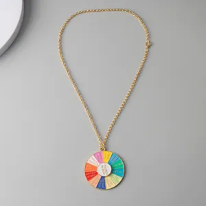 Gold chain necklace with colorful spinner pendant, funny decision wheel jewelry detail view.