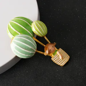 Detailed view of hot air balloon brooch featuring cute cartoon girl, enamel pin for suits.