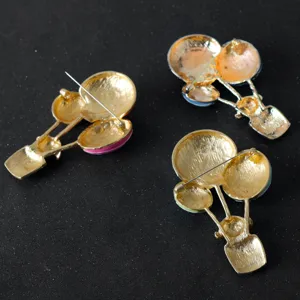 Gold-toned hot air balloon brooch pins back view, cute cartoon apparel accessories.