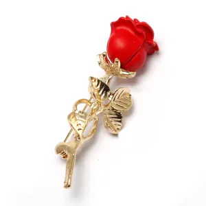 Elegant red rose brooch pin featuring gold plated stem and leaves for stylish outfits.