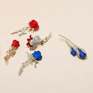 Detailed view of exquisite rhinestone rose flower brooches, elegant fashion jewelry pins.