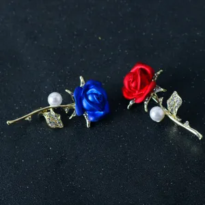 Detailed view of elegant rose brooches with colorful enamel flowers and sparkling rhinestones.