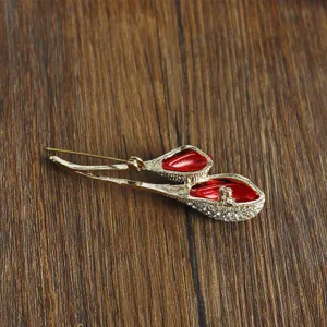 Exquisite rhinestone red rose brooch lapel pin, elegant gold metal floral jewelry accessory.