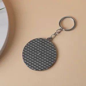 Alloy spinner keychain featuring a textured round pendant and secure key ring for daily use.