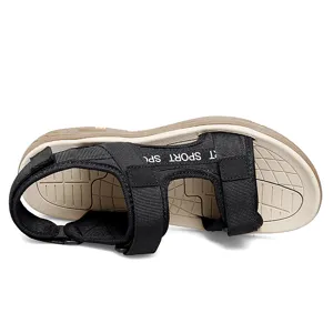 Men outdoor sport sandal detail, black strap with text and beige textured anti-slip sole.