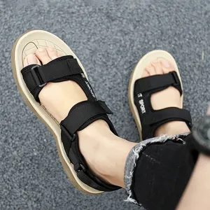 Detail view of men's outdoor sport sandals with black straps and comfortable beige soles.