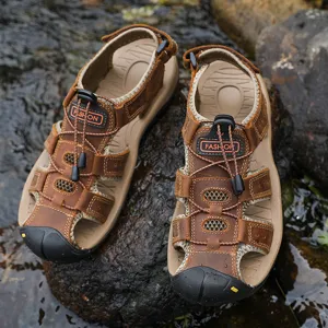 Detail view of men's outdoor leather sandals featuring protective toe cap and drawstring lace.