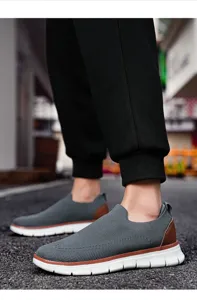 Men breathable knit casual slip-on shoes detail view showing textured grey upper sole.
