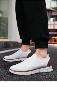 Close-up view of breathable knit casual men's sneakers showing mesh texture and slip-on fit.